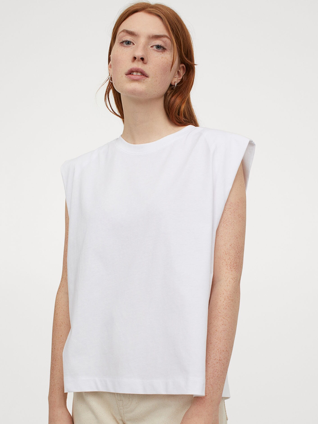 white sleeveless tees