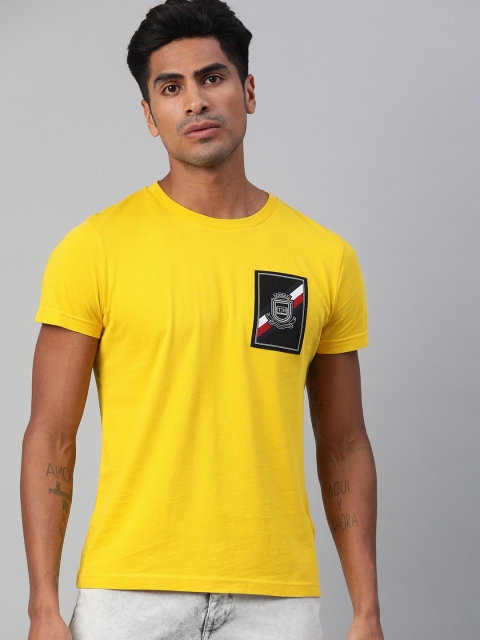

Tommy Hilfiger Men Mustard Yellow Organic Cotton Solid Round Neck T-shirt with Applique