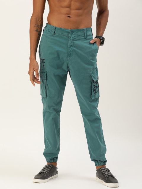 

Moda Rapido Men Sea Green Regular Fit Solid Joggers with Printed Pockets