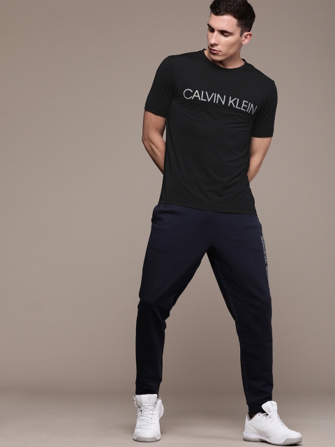 

Calvin Klein Jeans Men Black Solid Round Neck T-shirt with Printed Detailing