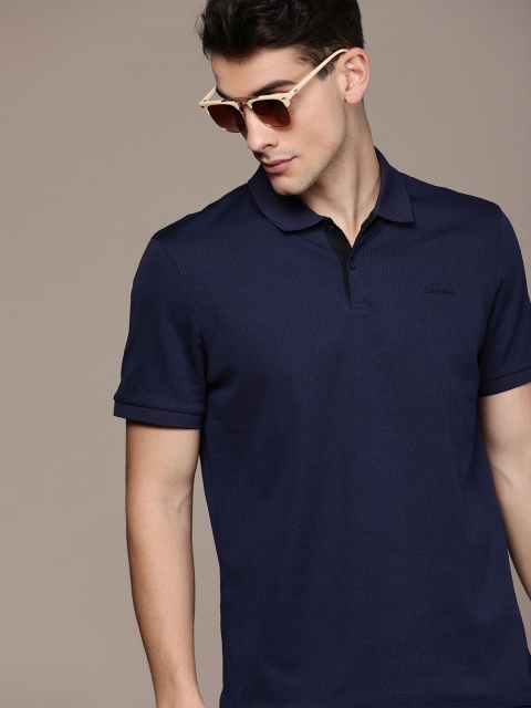 

Calvin Klein Jeans Men Navy Blue Self Design Polo Collar T-shirt