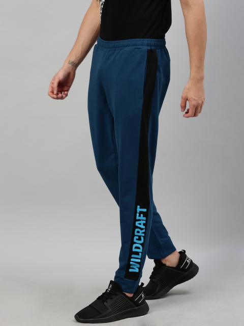 

Wildcraft Men Teal Blue Solid Straight Fit Joggers With Side Stripes, Navy blue