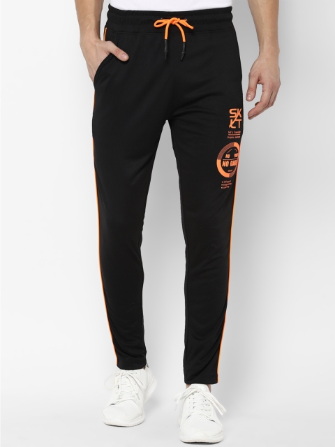 

SKULT by Shahid Kapoor Men Black Solid Straight Fit Track Pants with Printed Detail