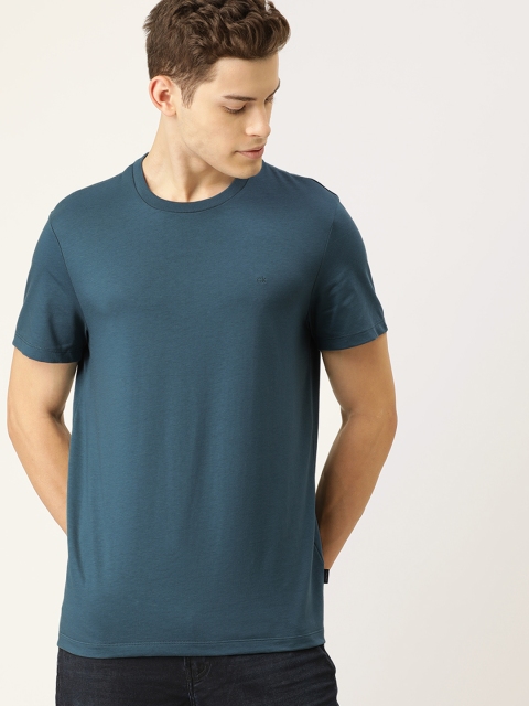 

Calvin Klein Jeans Men Teal Blue Solid Round Neck T-shirt
