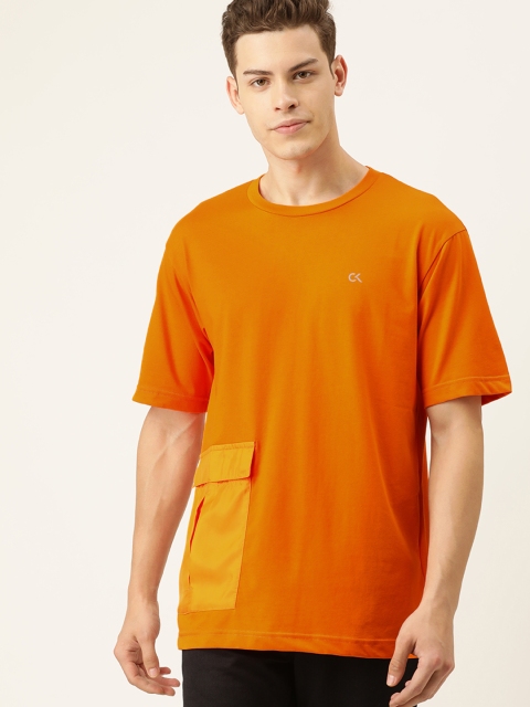 

Calvin Klein Jeans Men Orange Solid Round Neck T-shirt with Pocket Detail