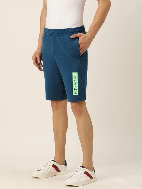 

Calvin Klein Jeans Men Teal Blue Solid Regular Fit Regular Shorts with Print Detail