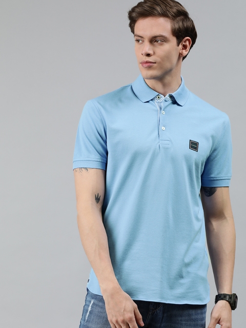 

Tommy Hilfiger Men Blue Solid Polo Collar T-shirt with Applique
