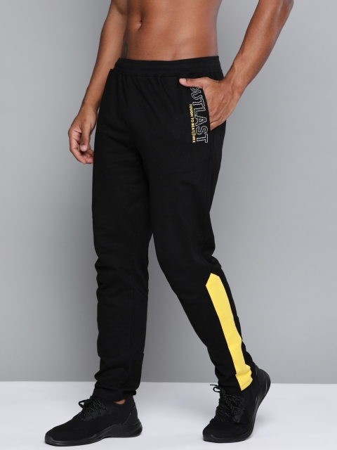 

HRX By Hrithik Roshan Men Jet Black & Aspen Gold Typographic Regular Fit Mid-Rise Bio-Wash Lifestyle Track Pants