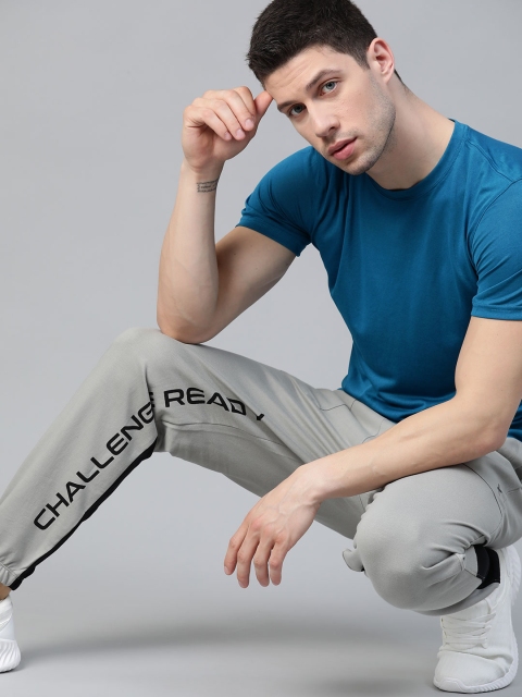 

HRX By Hrithik Roshan Men Wet Weather Typographic Regular Fit Bio-Wash Lifestyle Joggers, Grey