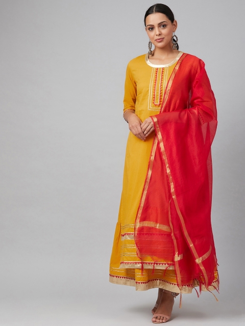 

Tulsattva Women Mustard & Red Solid Kurta with Skirt & Dupatta