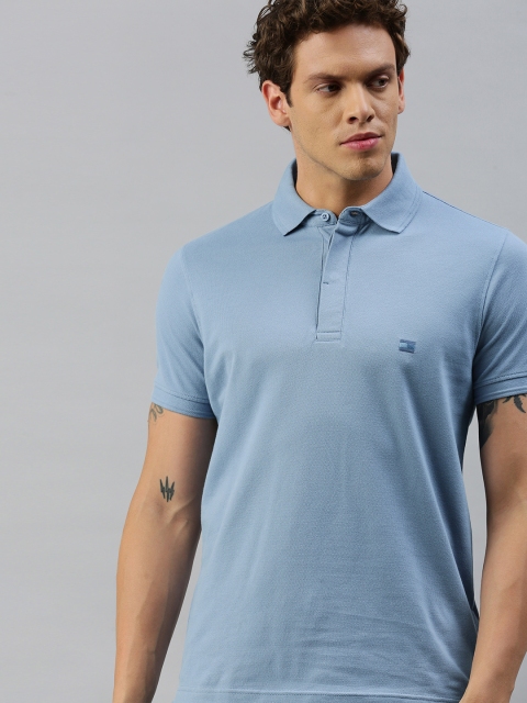

Tommy Hilfiger Men Blue Solid Polo Collar T-shirt