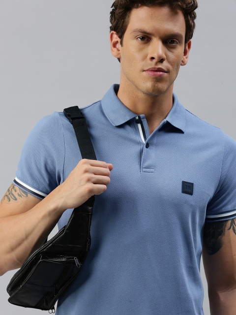 

Tommy Hilfiger Men Blue Solid Polo Collar Pure Cotton T-shirt