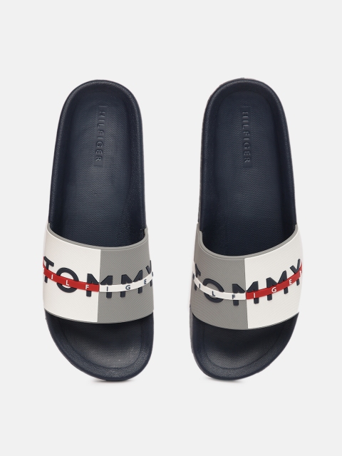

Tommy Hilfiger Men Navy Blue and White Self Design Sliders