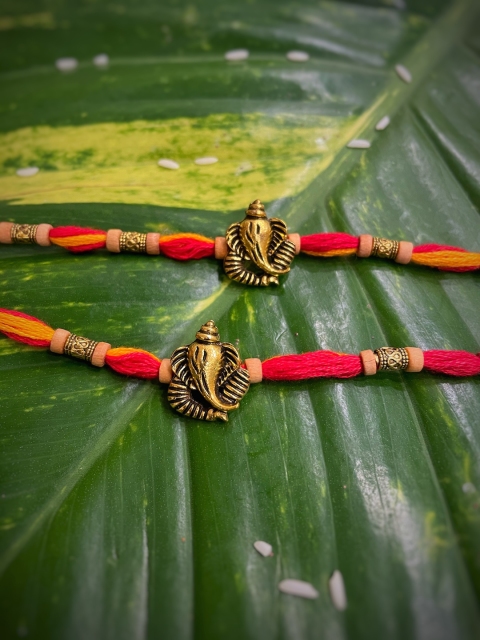 

Digital Dress Room Pack Of 2 Orange & Red Ganesh Ji Pendant Mauli Rakhis