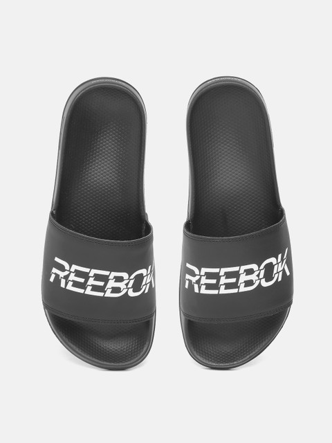 

Reebok Men Black & White Brand Logo Printed Comfort Sliders