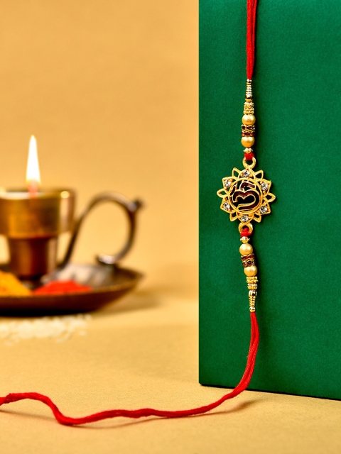 

Zaveri Pearls Red Enamelled Om Rakhi With Chawal Roli