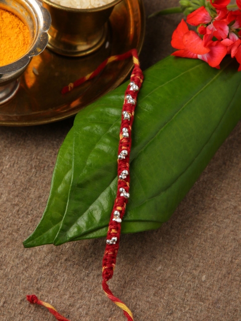 

Sepia Silver-Toned & Red Ghungroo 925 Rakhi With Roli and Akshada