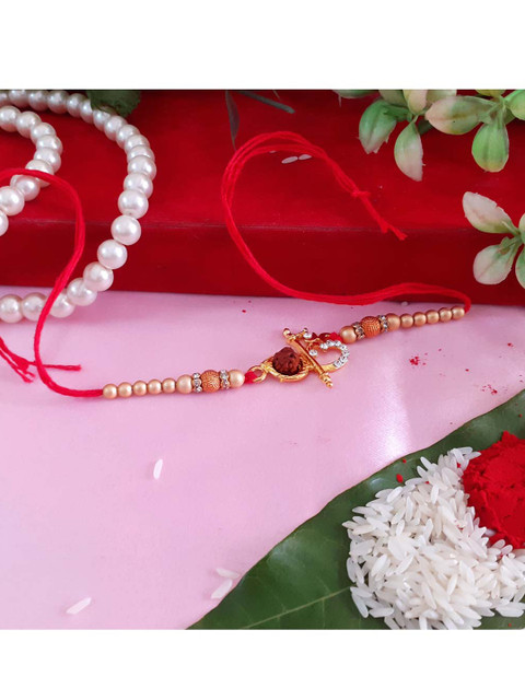 

Menjewell Red & Rose Gold-Toned Flute Om Textured Stone Studded Beaded Rakhi & Chawal Roli