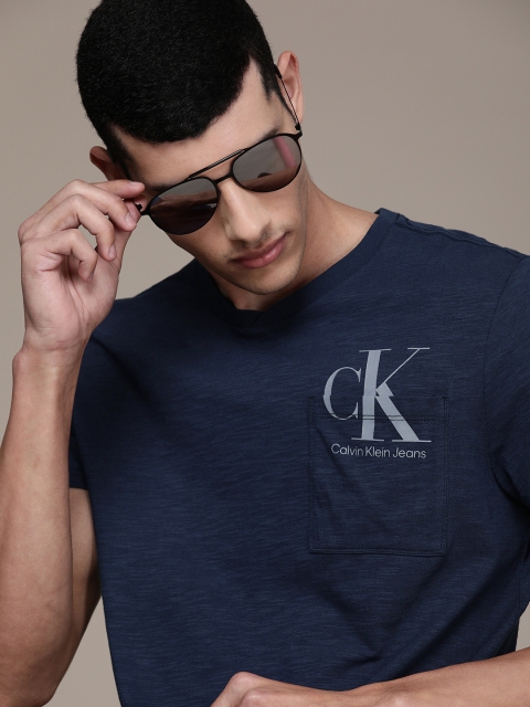 

Calvin Klein Jeans Men Blue Logo Printed Regular Fit Pure Cotton Casual Pocket Pure Cotton T-shirt
