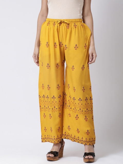

Charitra Women Mustard Yellow & Red Ethnic Motifs Printed Flared Ethnic Palazzos