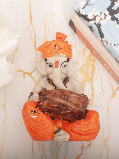 

Archies Cream & Orange Ganesha With Dholak Idol Showpiece