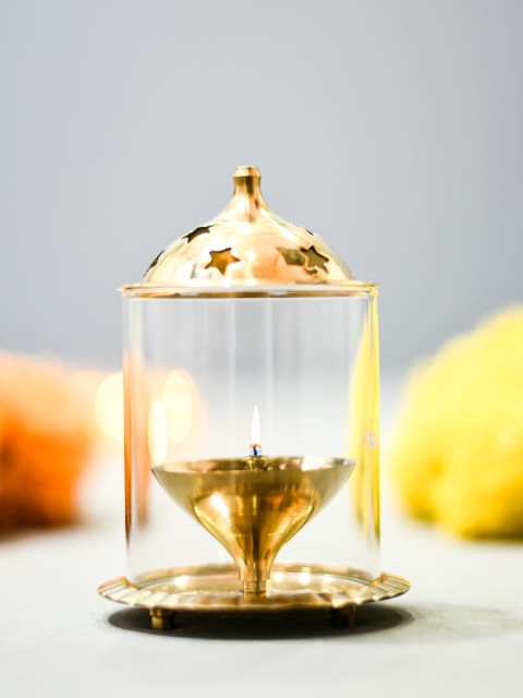 

Archies Gold-Toned & Yellow Glass Akhand Diya Oil Lamp Gift Set