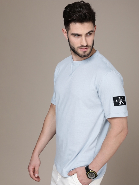 

Calvin Klein Jeans Men Light Blue Pure Cotton Solid T-shirt With Monogram Badge