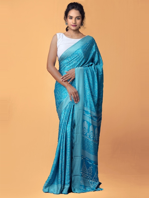 

Unnati Silks Blue & White Ethnic Motifs Patola Saree