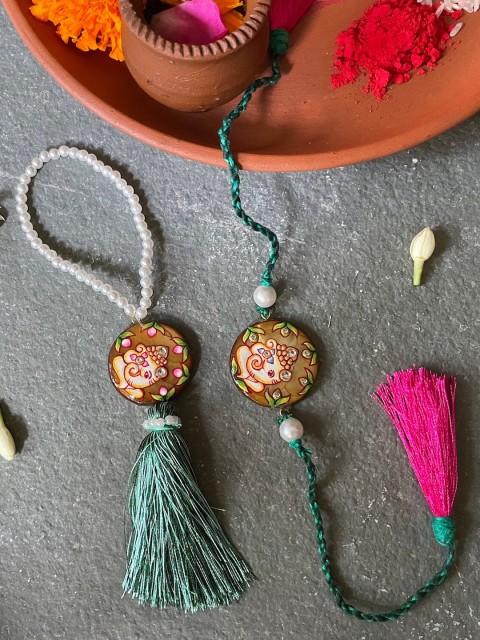 

Mitali Jain Pink & Green Ganesh Rakhi Lumba Set