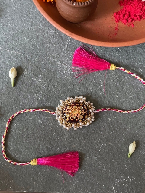

Mitali Jain Maroon Kundan Pearl Rakhi