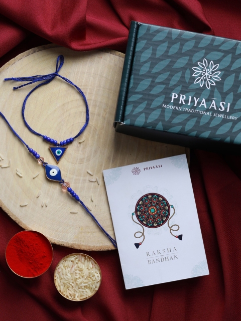 

Priyaasi Set Of 2 Blue Evil Eye Beaded Rakhi with Roli Chawal & Card