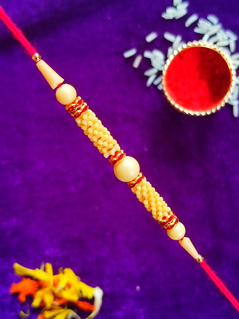 

CRAYTON Men Beige Pearl Beaded & Red Threaded Rakhi