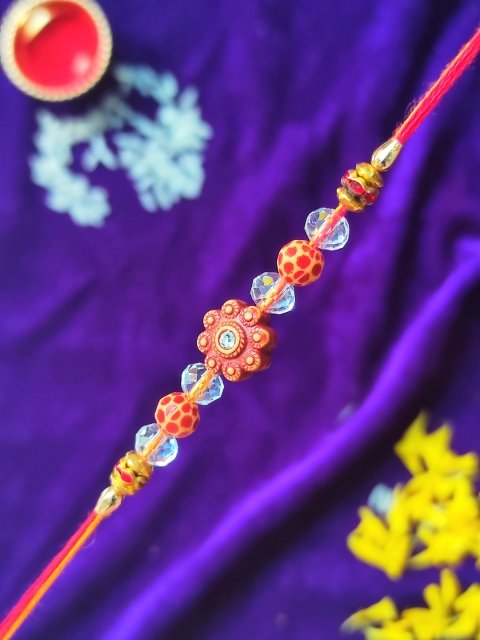

CRAYTON Men Blue & Beige Colored Diamond Flower Studded & Beaded Rakhi