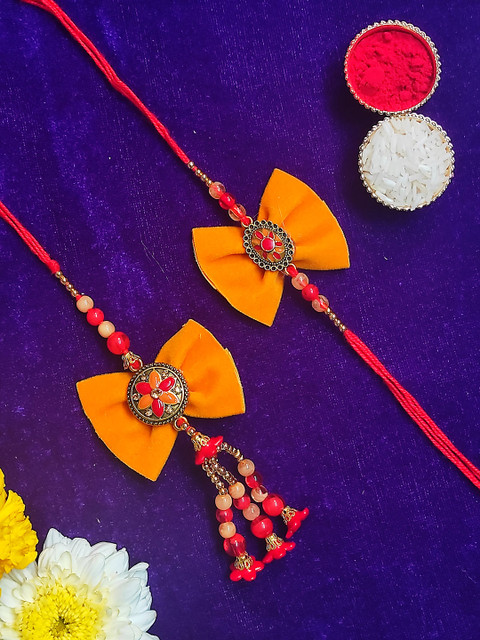 

CRAYTON Set of 2 Orange & Red Rustic Dial with Bow Bhaiya Bhabhi Rakhi