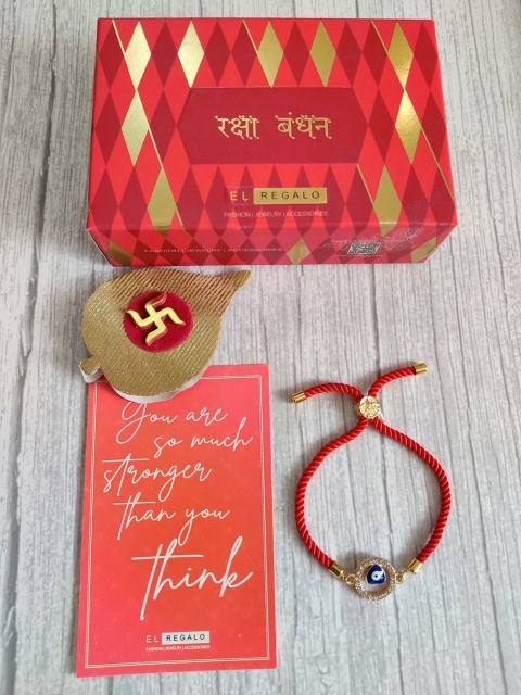 

EL REGALO Red & Gold Coloured Evil Eye Wrap Around Rakhi With Roli Chawal & Raksha Bandhan Greeting Card