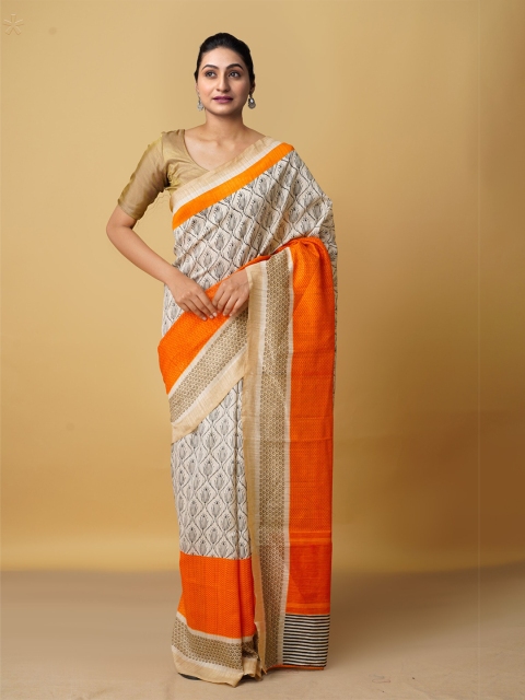 

Unnati Silks White & Orange Ethnic Motifs Zari Art Silk Block Print Saree