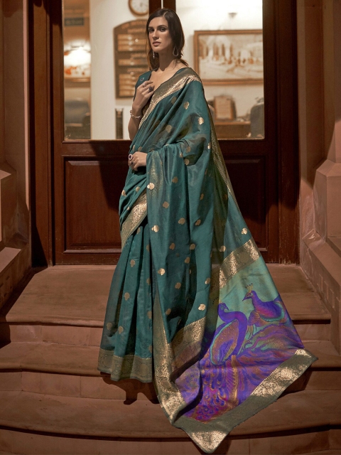 

Mitera Teal & Purple Ethnic Motifs Zari Silk Blend Banarasi Saree