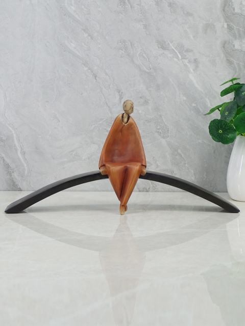 

HomeTown Brown Man Sitting On Cirque Showpiece