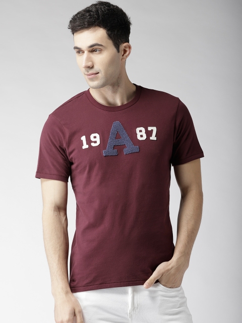 

Aeropostale Men Burgundy Solid Round Neck T-shirt with Applique Detail