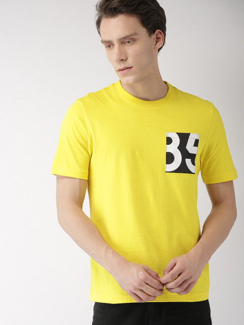 

Tommy Hilfiger Men Yellow Solid Round Neck T-shirt with Pocket Detailing