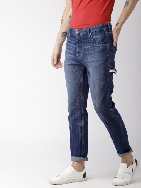 

Tommy Hilfiger Men Blue Tapered Carpenter Fit Mid-Rise Clean Look Jeans