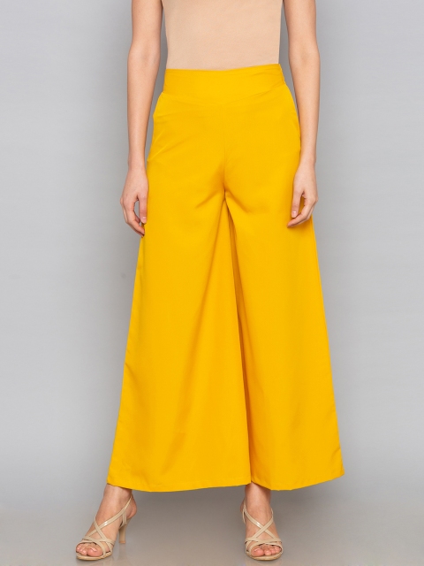 

Desi Weavess Women Yellow Flared Solid Palazzos
