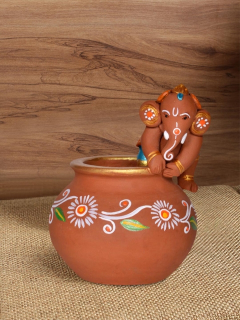 

ExclusiveLane Brown Terracotta Hand-Painted Baby Ganesha Crawling On The Matki
