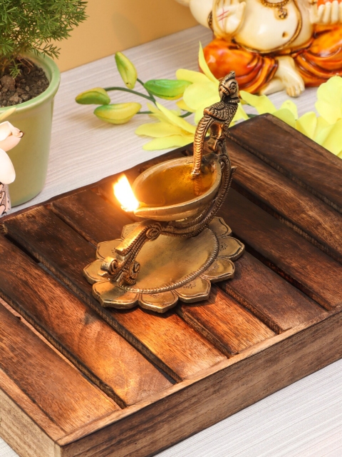 

Imli Street Gold-Toned Brass Peacock Shaped Diya