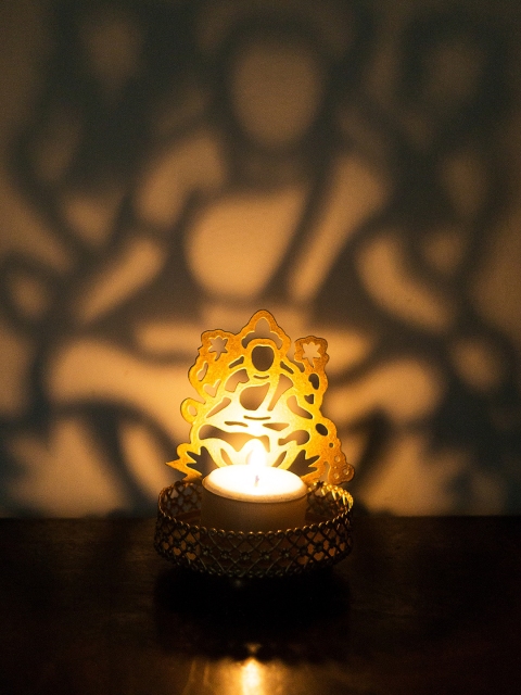 

Golden Peacock Gold-Toned Textured Metal Goddess Laxmi-Shaped Tea Light Holder