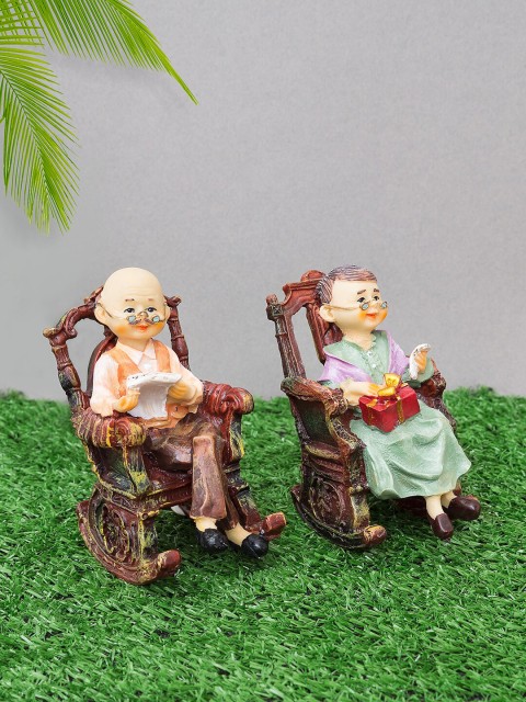 

Golden Peacock Brown & Green Old Couple Sitting On Chair 2 Piece Showpiece