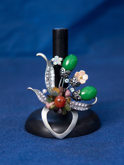 

Golden Peacock Women Silver-Toned & Green Stone Studded Floral Shaped Brooch