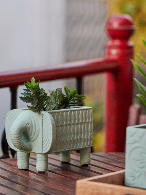 

Chumbak Sea Green Elephant Carved Rectangle Planter With Legs