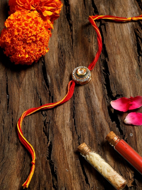 

Ruby Raang Kundan Red & Gold Rakhi Kundan Rakhi Gift Box With Rice & Vermilion