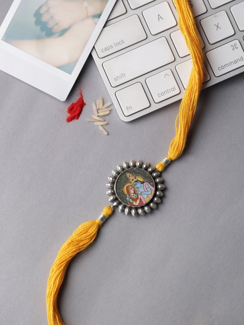 

ADORN by Nikita Ladiwala Sterling Silver Yellow Radha Krishan Rakhi With Roli Chawal